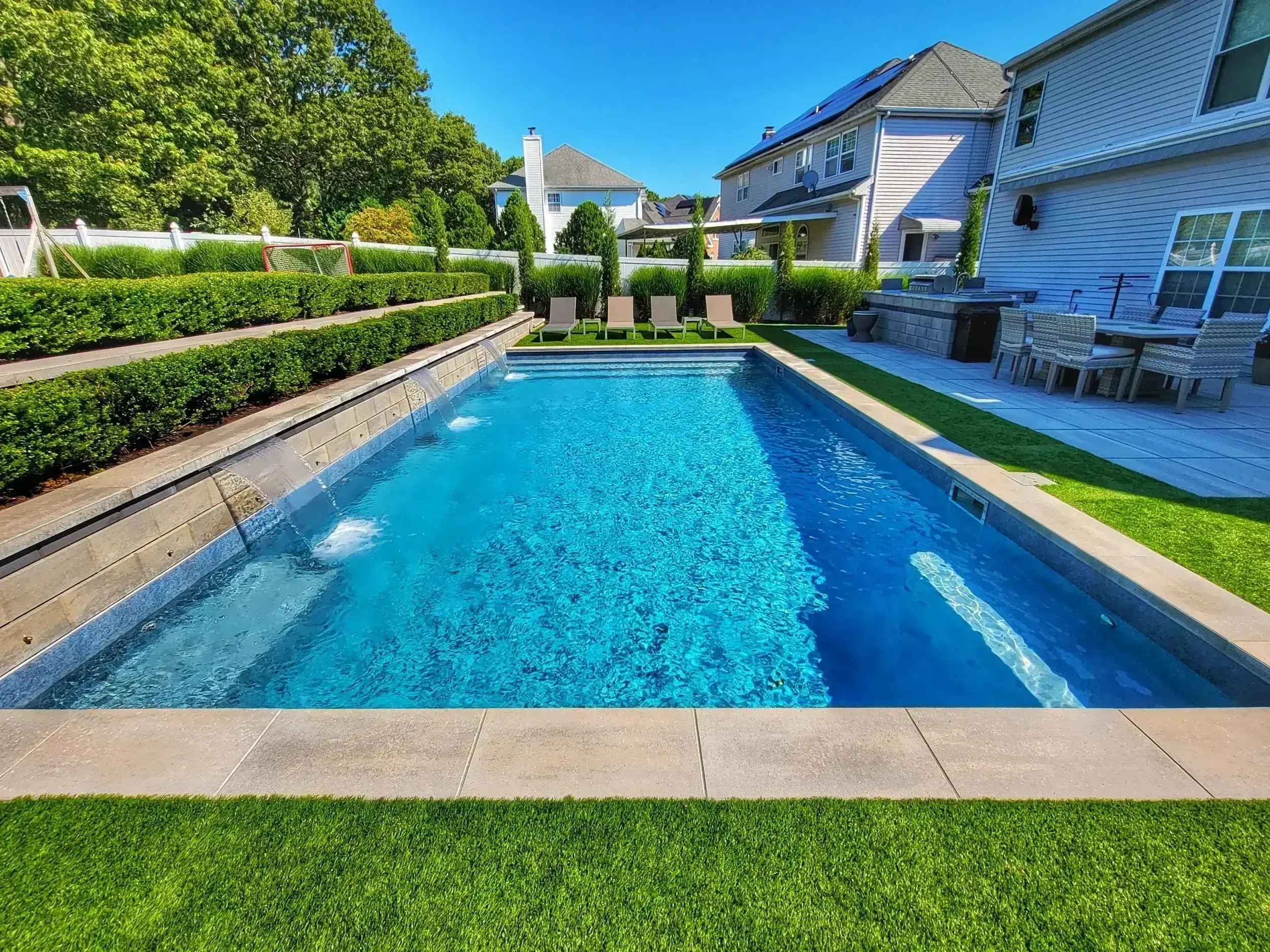 Swimming Pools and Spas Contractor installing an in-ground pool in Sunset Ridge Cochrane backyard